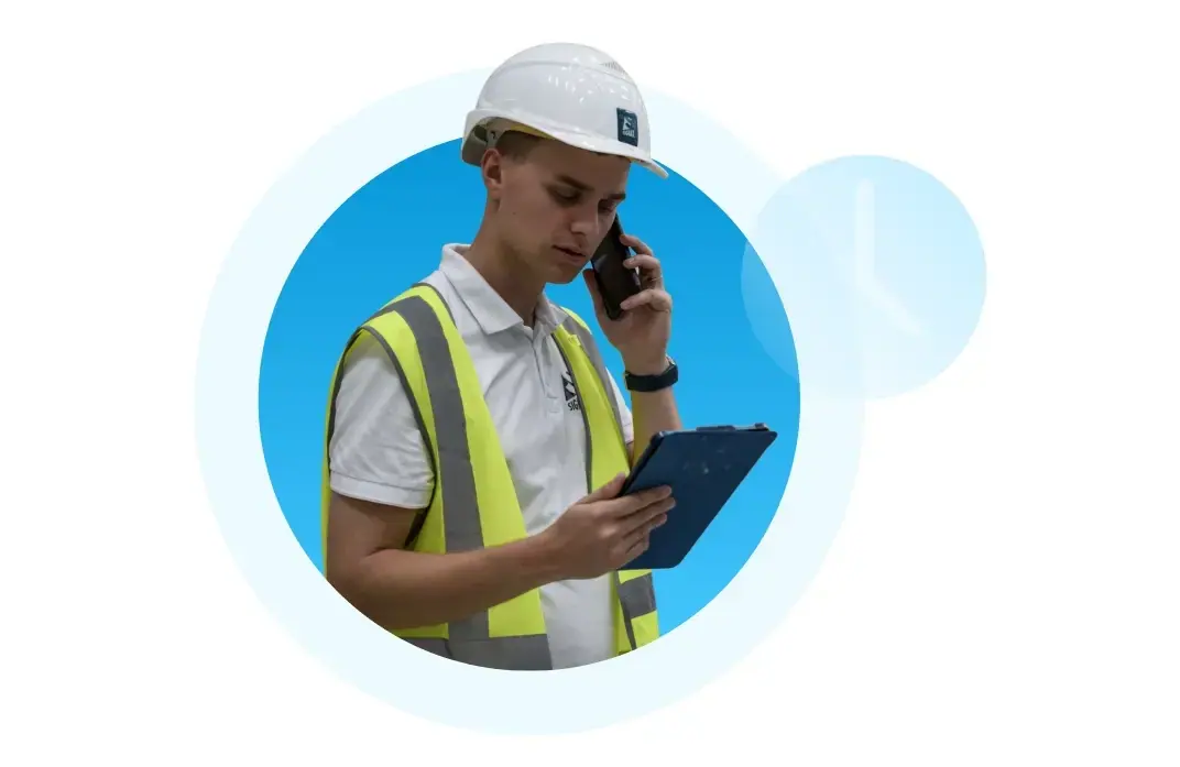A construction site engineer using a tablet to update digital reports